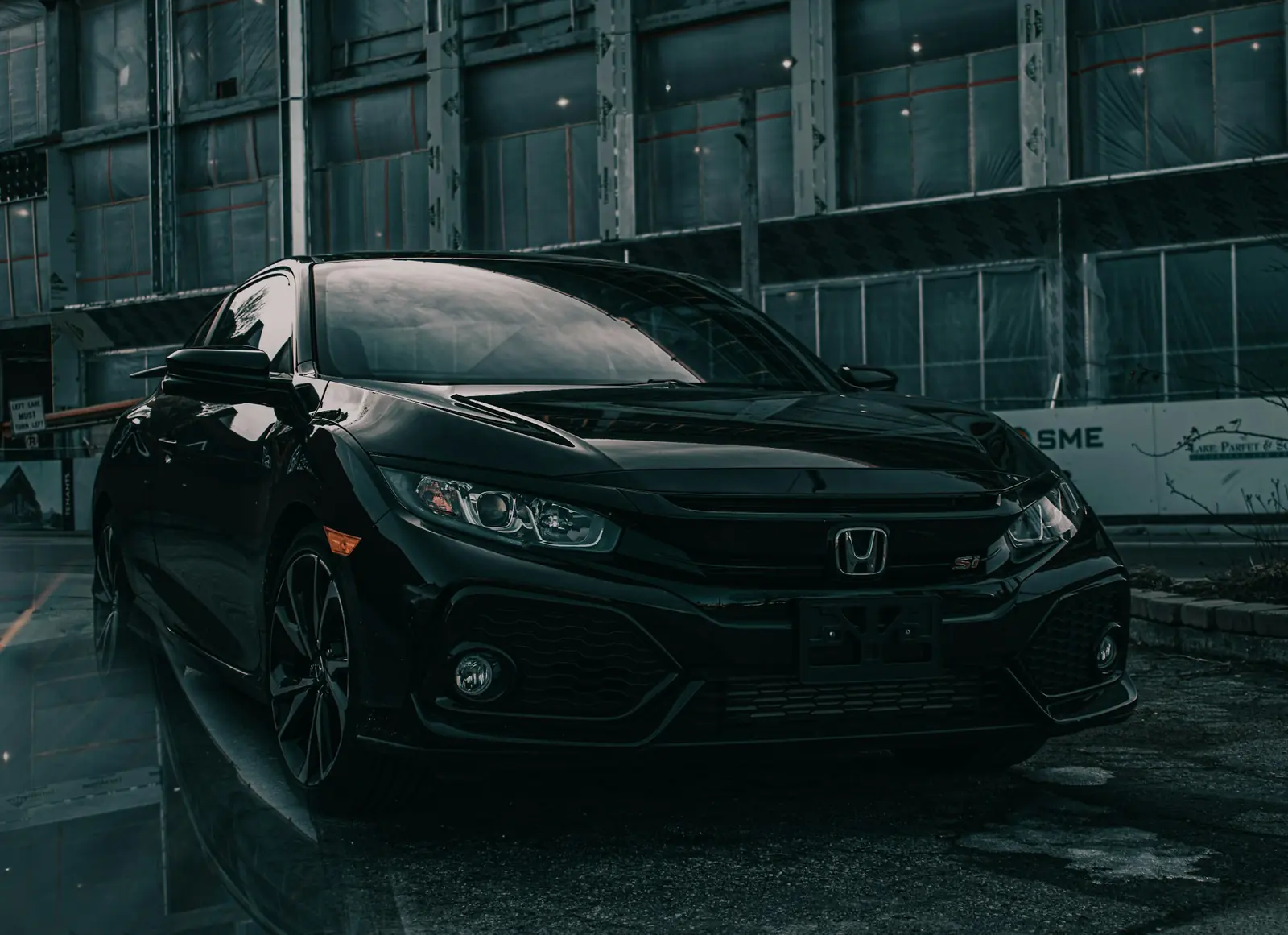 Black Honda Civic in an industrial street